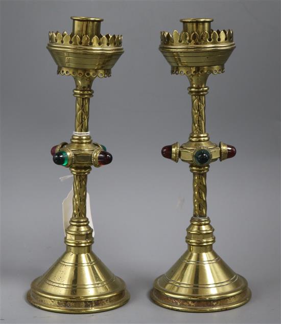 A pair of Gothic revival brass candlesticks, height 10in.